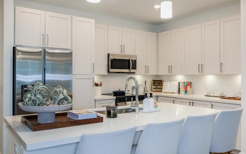 a kitchen with white cabinets