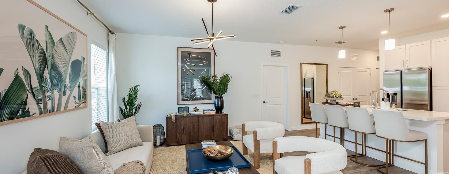living area with well-lit spaces for seating and a easy connection to the kitchen