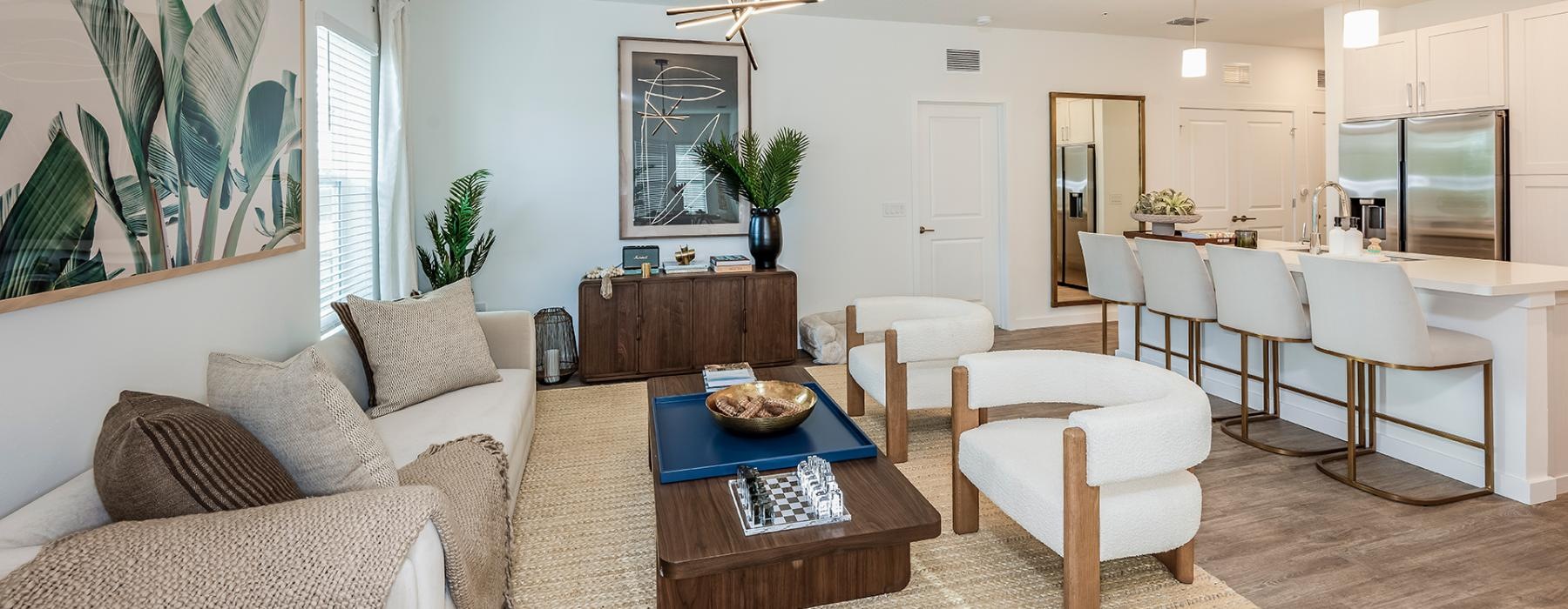 living area with well-lit spaces for seating and a easy connection to the kitchen